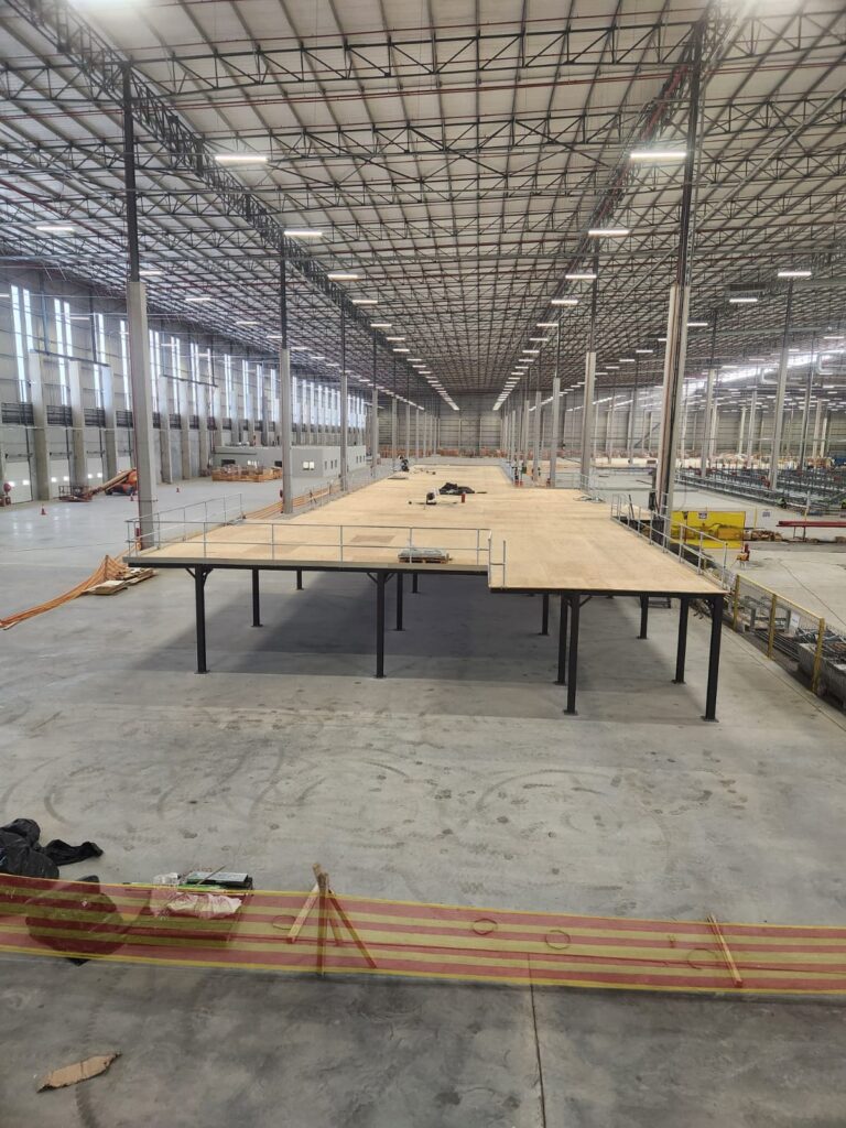 Warehouse mezzanine installation with exposed flooring.