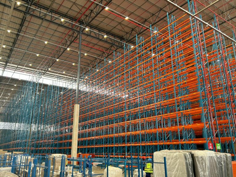 Very Narrow Aisle Racking Orange and Blue getting installed half way