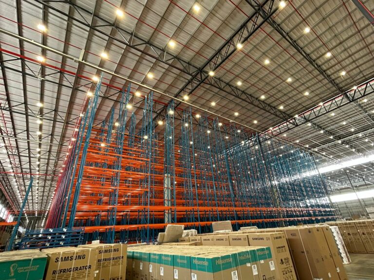 Very Narrow Aisle Racking Orange and Blue installed and boxes ready to be packed